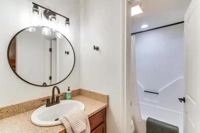 a bathroom with a sink and a mirror at Hike, Bike, Ski Winter Park Condo with Deck in Winter Park