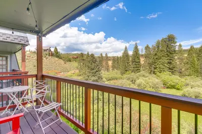a balcony with chairs and a view of the mountains at Hike, Bike, Ski Winter Park Condo with Deck in Winter Park