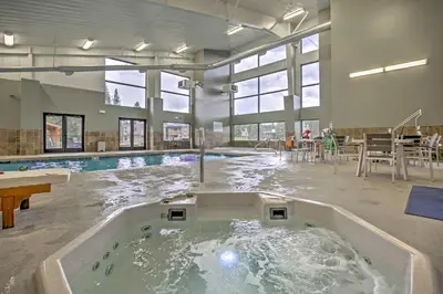 a large indoor pool with a hot tub in the middle at Hike, Bike, Ski Winter Park Condo with Deck in Winter Park