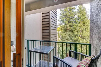 a balcony with two chairs and a table and a window at Cozy Ski-InandSki-Out Winter Park Condo with Pool! in Winter Park
