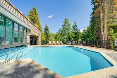 a swimming pool in the backyard of a house at Cozy Ski-InandSki-Out Winter Park Condo with Pool! in Winter Park