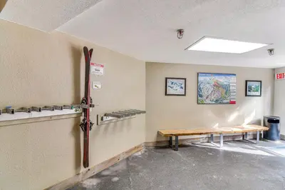 a room with a table and a bench in it at Cozy Ski-InandSki-Out Winter Park Condo with Pool! in Winter Park