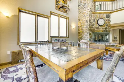 a dining room with a table and chairs at Cozy Ski-InandSki-Out Winter Park Condo with Pool! in Winter Park
