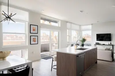a kitchen with a sink and a living room at Serenity in Style | Espadin LoHi in Denver