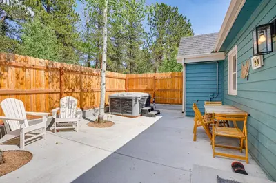 a patio with chairs and a grill and a fence at Patio and Hot Tub Cozy Cabin Retreat in Bailey! in Bailey