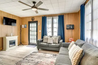 a living room with a couch and a chair at Patio and Hot Tub Cozy Cabin Retreat in Bailey! in Bailey