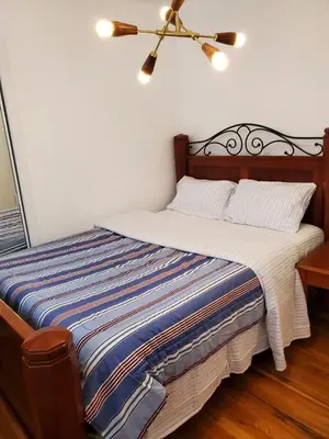 a bed in a bedroom with a ceiling fan at 7 bedroom 8 beds family house in Denver