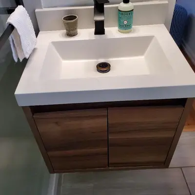 a white bathroom sink with a wooden cabinet under it at 7 bedroom 8 beds family house in Denver