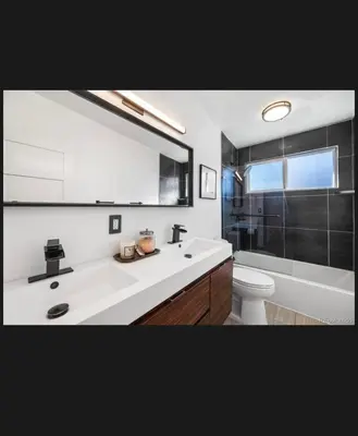 a bathroom with a sink and a toilet and a mirror at 7 bedroom 8 beds family house in Denver