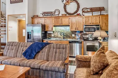 a living room with a couch and a kitchen at 2BR Keystone Condo Near Ski Lifts and Trails in Keystone