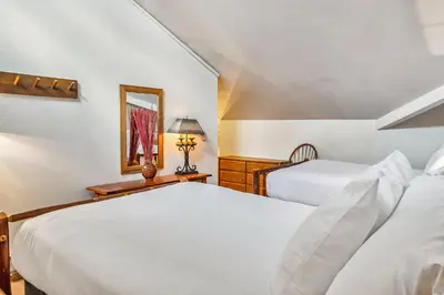 a bedroom with two beds and a mirror at 2BR Keystone Condo Near Ski Lifts and Trails in Keystone