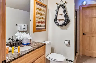 a bathroom with a sink and a toilet and a mirror at 2BR Keystone Condo Near Ski Lifts and Trails in Keystone