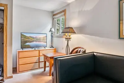a living room with a desk and a television at 2BR Keystone Condo Near Ski Lifts and Trails in Keystone