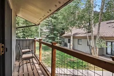 a porch with a chair on a wooden deck at 2BR Keystone Condo Near Ski Lifts and Trails in Keystone