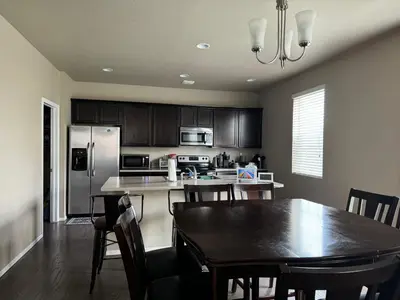 a kitchen with a wooden table and a dining room at Humble Home in Aurora