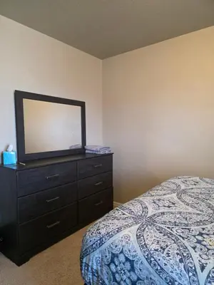 a bedroom with a dresser with a mirror on it at Humble Home in Aurora