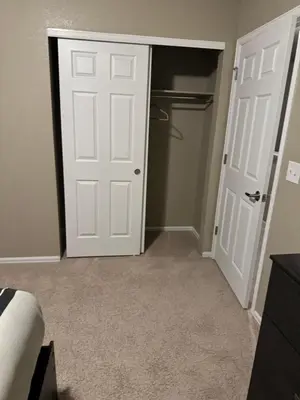 an empty room with a door and a closet at Humble Home in Aurora