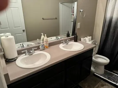 a bathroom with two sinks and a toilet at Humble Home in Aurora