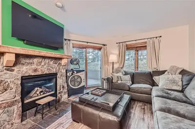 a living room with a couch and a fireplace at 2225 Red Hawk condo in Keystone