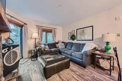 a living room with a couch and a table at 2225 Red Hawk condo in Keystone