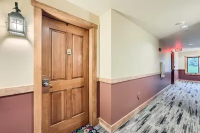 a hallway with a wooden door in a room at 2225 Red Hawk condo in Keystone