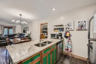 a kitchen with a sink and a refrigerator at 2225 Red Hawk condo in Keystone