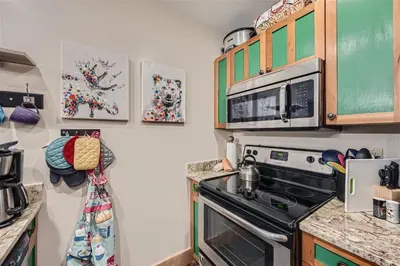 a kitchen with a stove and a microwave at 2225 Red Hawk condo in Keystone