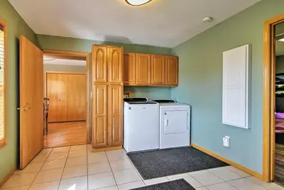 a kitchen with a white refrigerator and wooden cabinets at Evergreen Ranch Family Vacation Home, Sleeps 8, Private Hot Tub in Granby