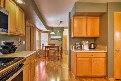 a kitchen with wooden cabinets and a dining room at Evergreen Ranch Family Vacation Home, Sleeps 8, Private Hot Tub in Granby