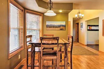 a dining room with a wooden table and chairs at Evergreen Ranch Family Vacation Home, Sleeps 8, Private Hot Tub in Granby