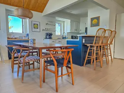 a kitchen with a wooden table and chairs at The Rail Haven townhouse in Winter Park