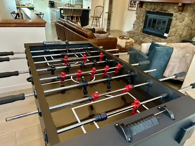 a ping pong table in a living room at The Rail Haven townhouse in Winter Park