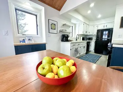 a bowl of fruit on a wooden table in a kitchen at The Rail Haven townhouse in Winter Park