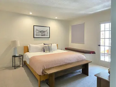a bedroom with a large bed and a window at The Rail Haven townhouse in Winter Park