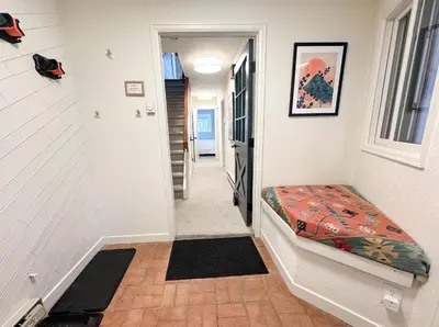 a hallway with a bench in a house at The Rail Haven townhouse in Winter Park