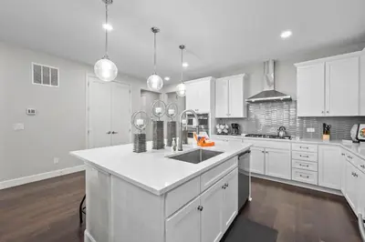 a white kitchen with white cabinets and a sink at Ouray Street - Commerce City in Henderson