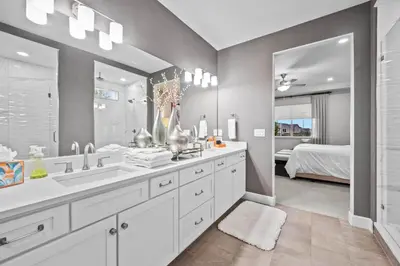 a bathroom with two sinks and a large mirror at Ouray Street - Commerce City in Henderson
