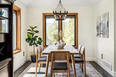 a dining room with a table and chairs and a window at Hot Tub - Scenic Views - Spacious Deck - Game Room in Evergreen