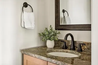 a bathroom with a sink and a mirror at Hot Tub - Scenic Views - Spacious Deck - Game Room in Evergreen