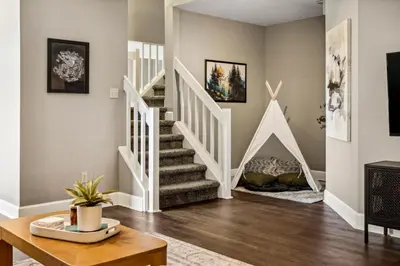 a living room with stairs and a fireplace at Hot Tub - Scenic Views - Spacious Deck - Game Room in Evergreen