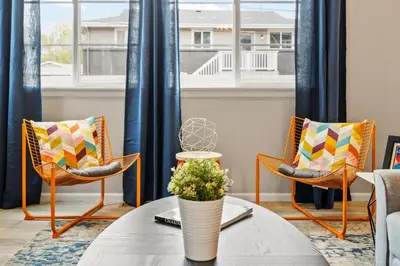 a living room with chairs and a table with a vase at Sunny & Quaint Hidden Gem w Office - Dog Friendly in Westminster