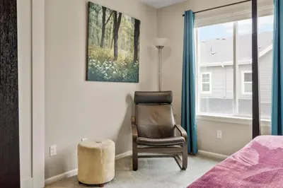 a bedroom with a chair and a window at Sunny & Quaint Hidden Gem w Office - Dog Friendly in Westminster
