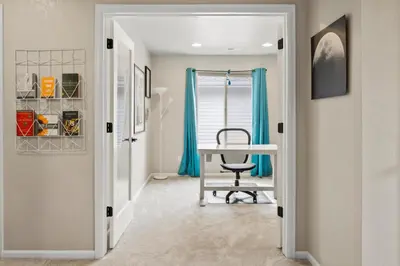 a hallway with a desk and a chair at Sunny & Quaint Hidden Gem w Office - Dog Friendly in Westminster