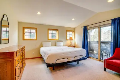 a bedroom with a bed and a red chair at 8 Mi to Skiing Mtn-View Getaway in Frisco! in Frisco