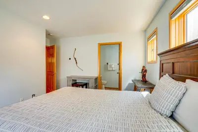 a bedroom with a large bed with a wooden headboard at 8 Mi to Skiing Mtn-View Getaway in Frisco! in Frisco