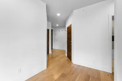 an empty hallway with white walls and wood floors at Blue R Flats Bld 3 203 in Silverthorne