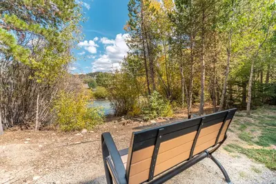 a park bench sitting in front of a body of water at Blue R Flats Bld 3 203 in Silverthorne