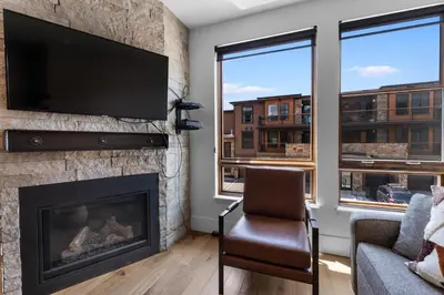 a living room with a fireplace and a flat screen tv at Blue R Flats Bld 3 203 in Silverthorne