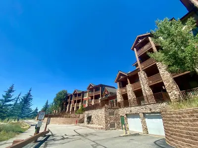 a large apartment building on the side of a street at Hidden River Lodge 5969 by SummitCove Lodging in Keystone