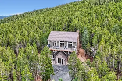 an aerial view of a house in the middle of a forest at Rocky Mountain Retreat home in Nederland